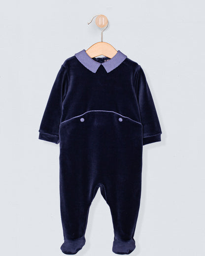 Navy Italian velour footie with a blue gingham Peter Pan collar and decorative pocket seam detail, displayed on wooden hanger.