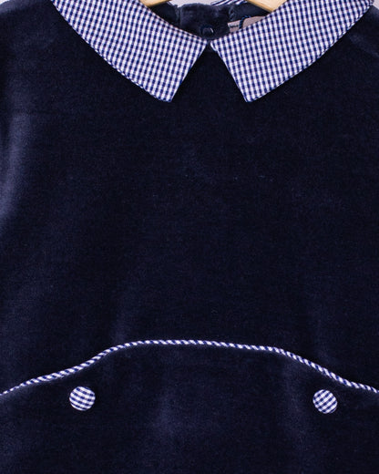 Detail view of navy velour footie highlighting the soft texture, gingham Peter Pan collar, and contrast piping on the seam.