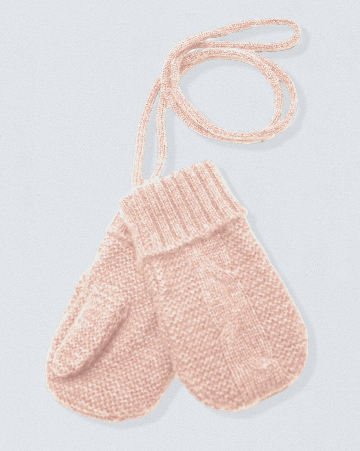 Pair of beige knitted mittens on a light gray background