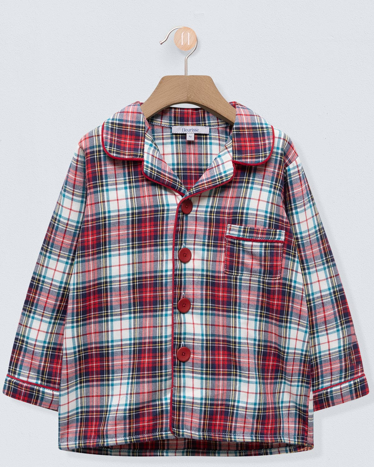 Plaid shirt on a hanger against a light gray background