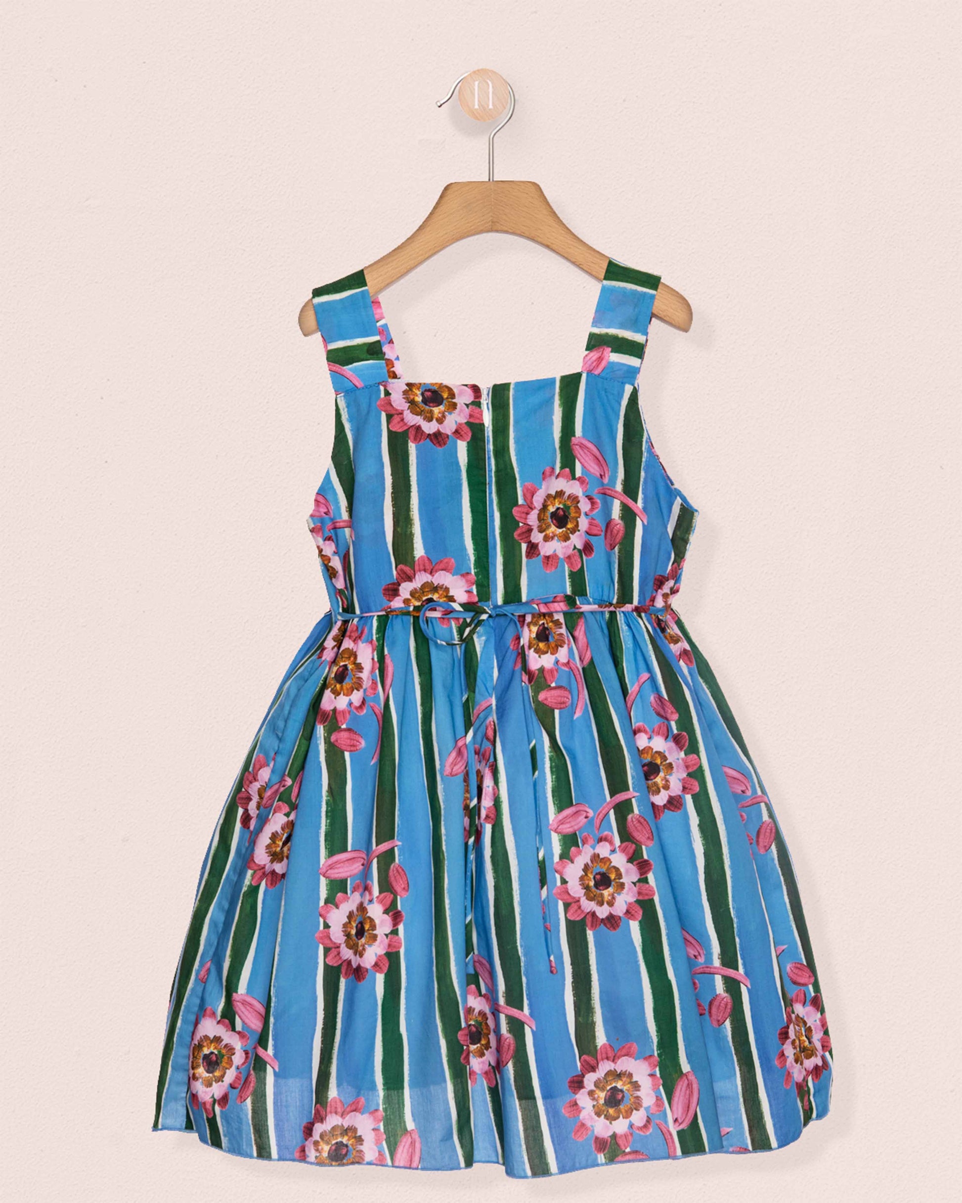 Blue and green striped dress with floral patterns on a beige background
