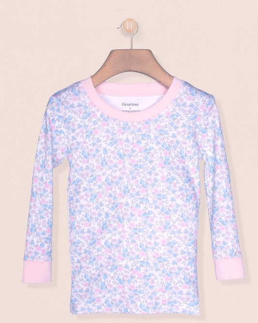 Floral-patterned long-sleeve shirt on a hanger against a beige background