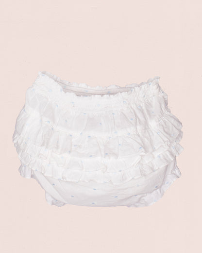 White ruffled diaper on a light pink background
