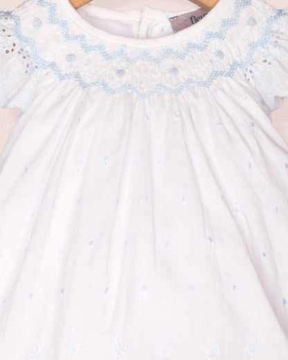 White dress with blue embroidery on a white background