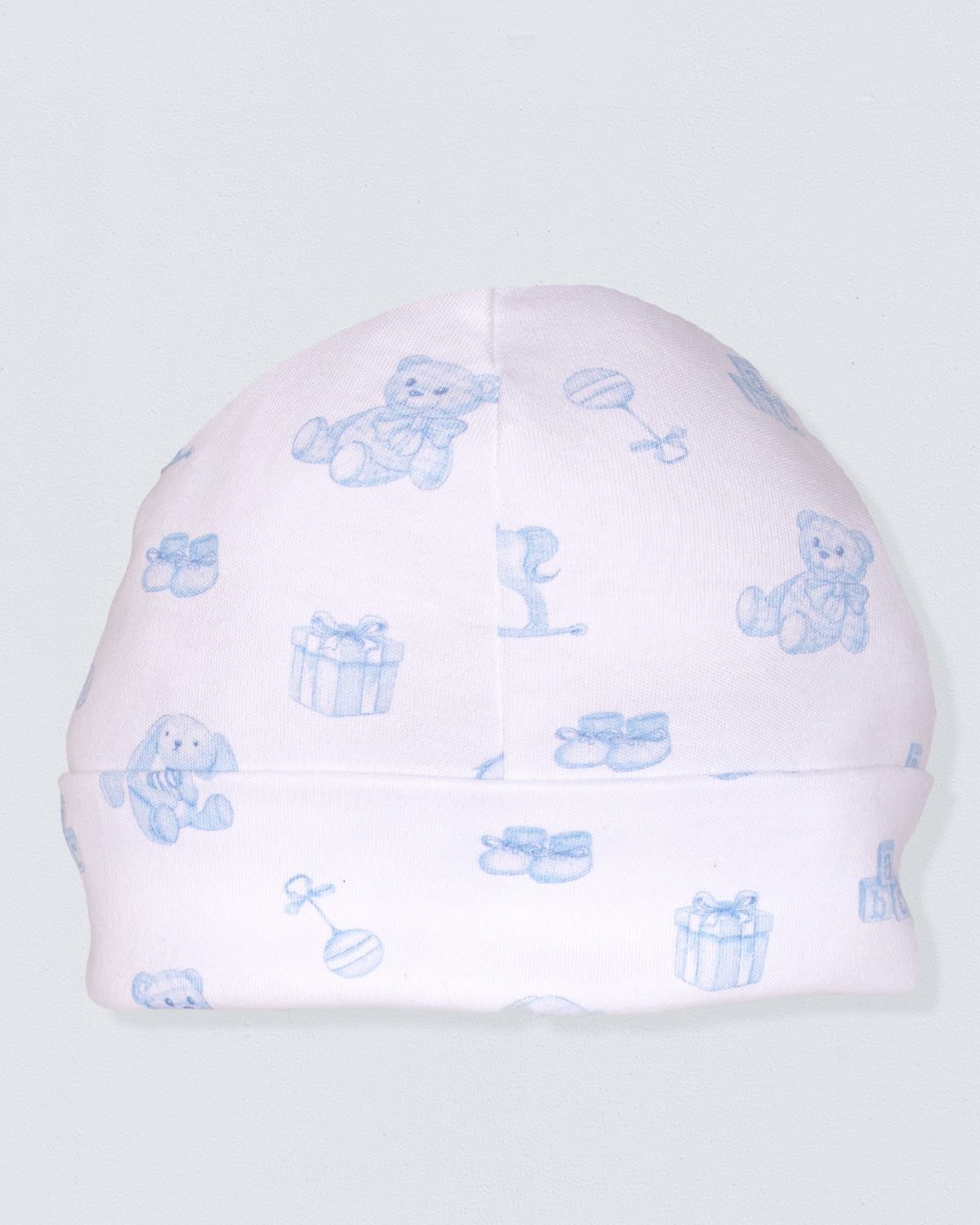 Pink baby hat with blue teddy bear and gift box patterns on a light gray background