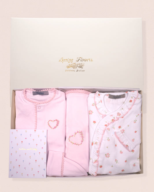 Set of three baby outfits in a box with 'Gentle Touch' branding.