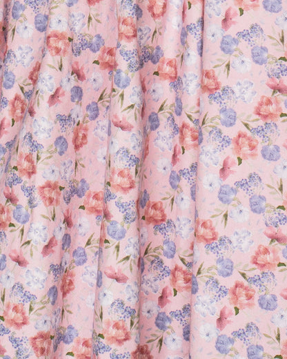 Floral patterned fabric with pink, blue, and green colors on a light pink background.
