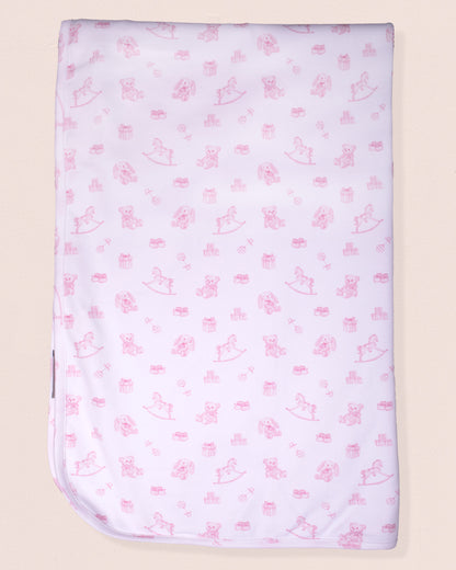 Baby blanket with pink animal pattern on a beige background