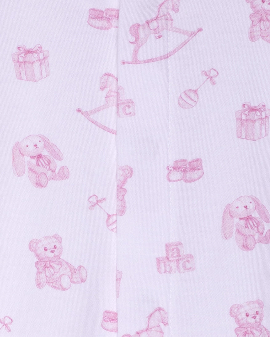 Pink baby toys and items on a white background