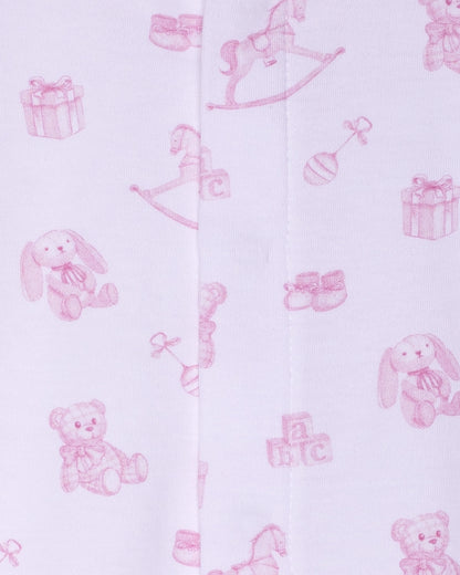Pink baby toys and items on a white background