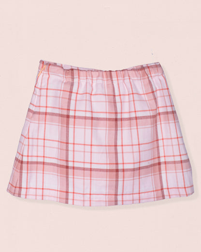 Back of plaid skirt with pink and white pattern on a beige background