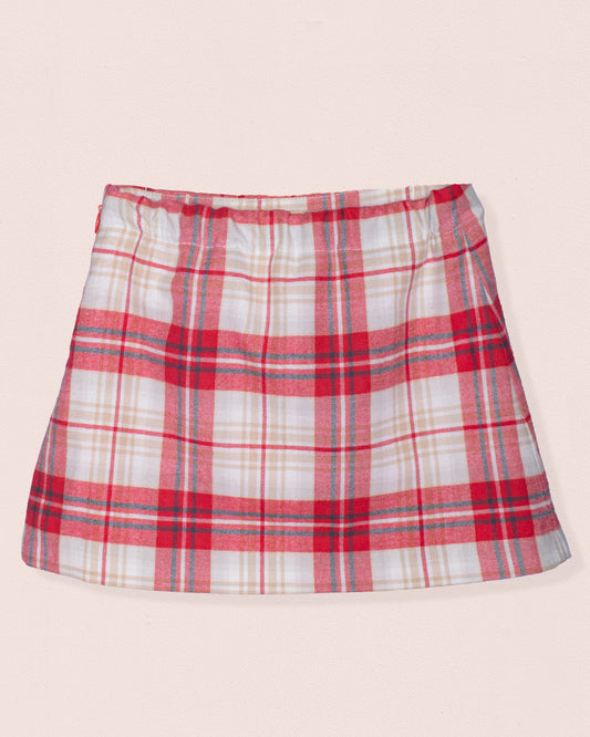 Plaid skirt with red, white, and blue pattern on a beige background