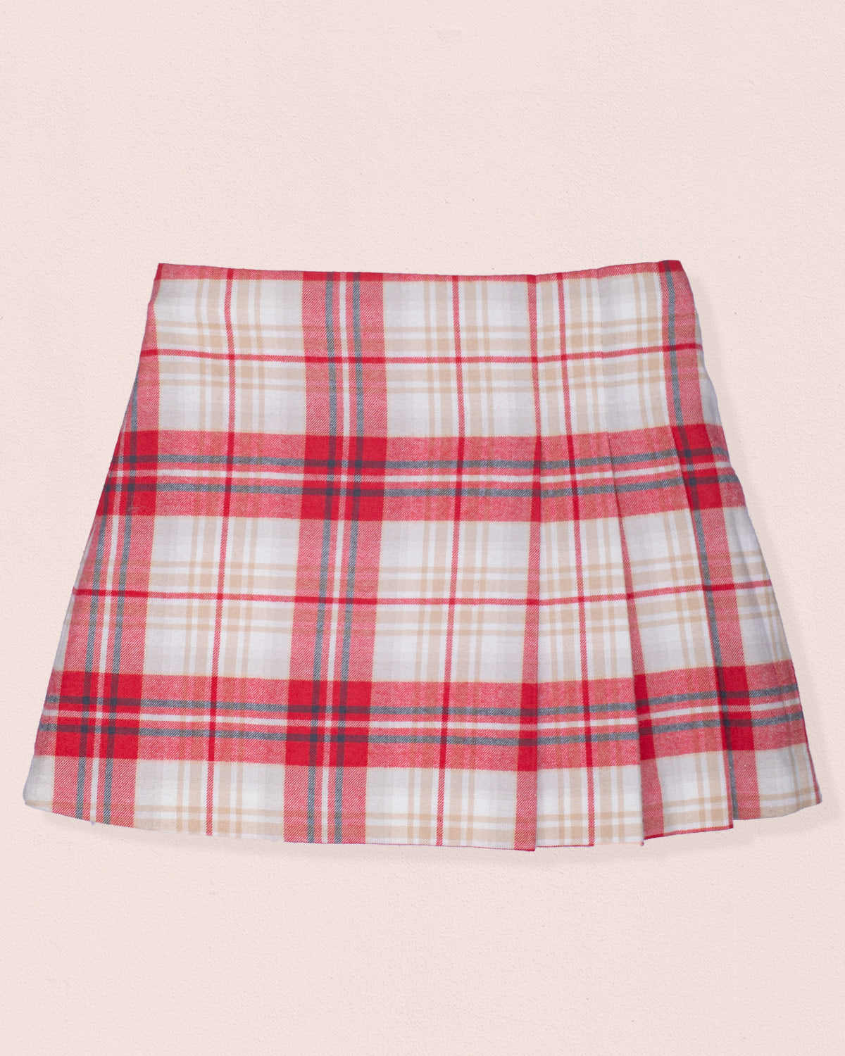 Front of plaid skirt with red, white, and blue pattern on a light pink background
