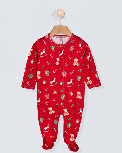Red baby onesie with Christmas pattern on a hanger against a light gray background