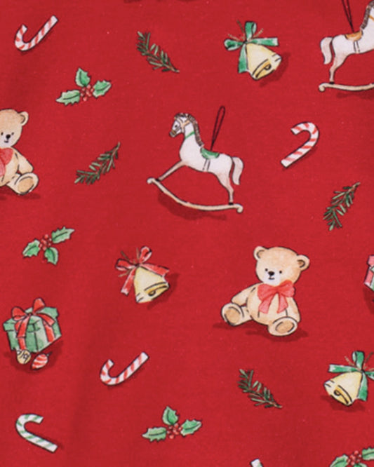 Red fabric with Christmas-themed pattern including teddy bears, rocking horses, candy canes, and bells.