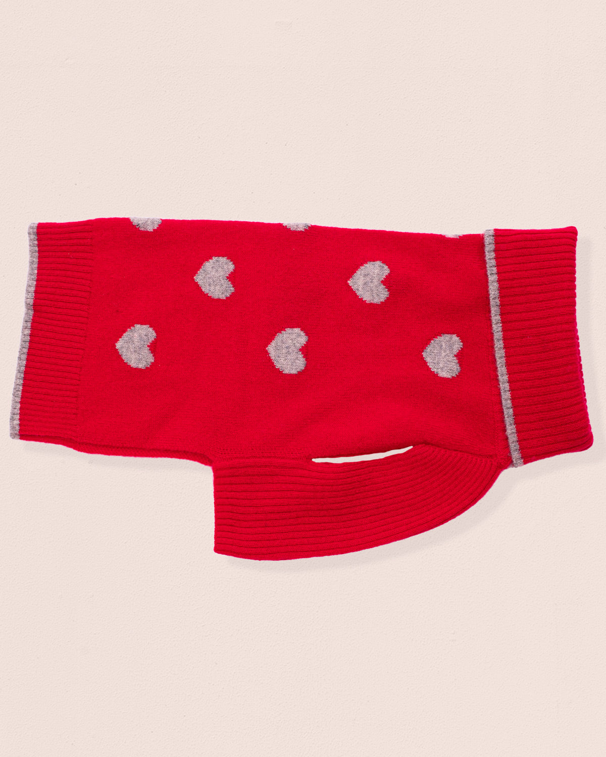 Red sweater for dogs, with gray hearts on a beige background