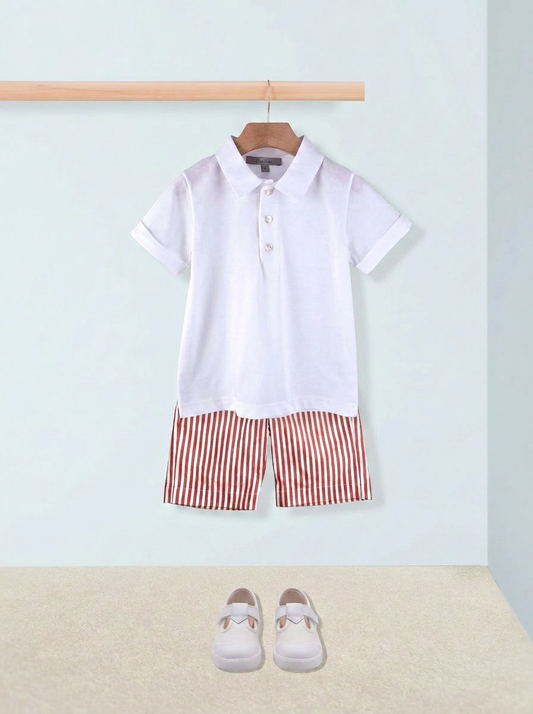 White polo shirt with red striped shorts on a hanger against a light blue wall.
