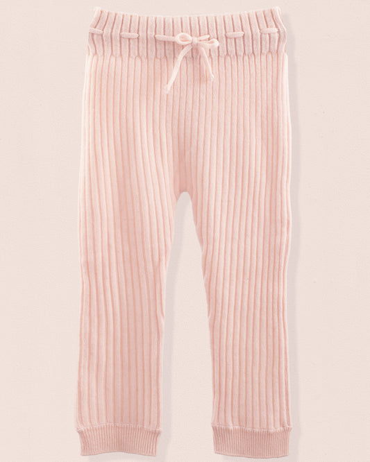 Pink ribbed jogger pants on a light pink background