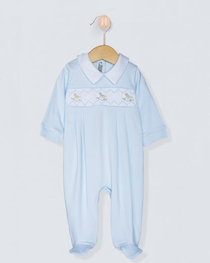 Light blue baby romper with smocking details on a white background