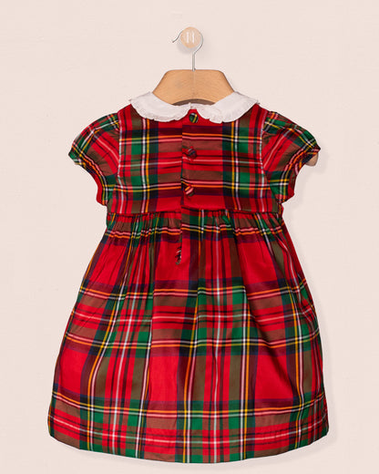 back of Red and green plaid dress with a white collar on a beige background
