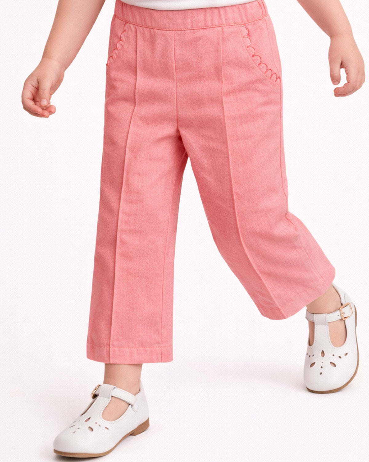Pink pants worn by a child on a white background
