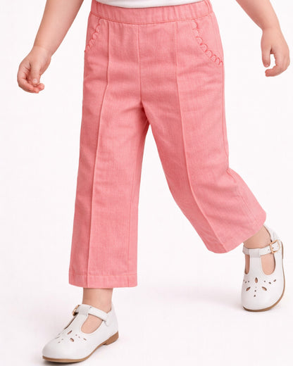 Pink pants worn by a child on a white background