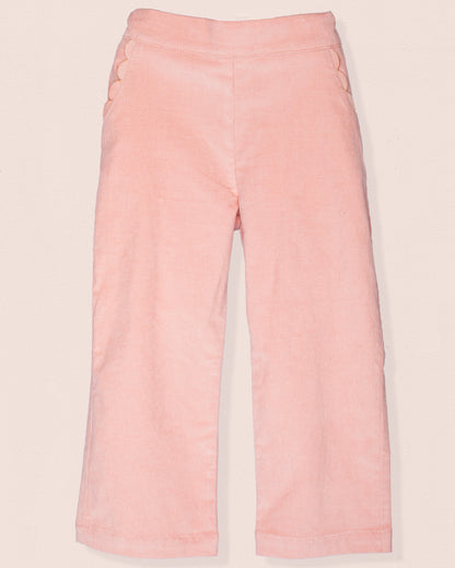 Front view of ruby pink Italian corduroy pull-on pants with scalloped front pocket detailing.