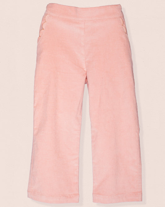 Front view of ruby pink Italian corduroy pull-on pants with scalloped front pocket detailing.