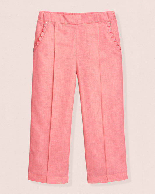 Pink pants with decorative buttons on a light pink background