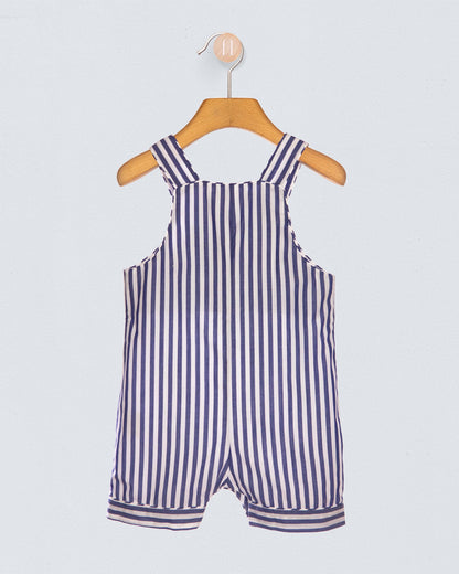Navy and white striped romper on a wooden hanger against a light gray background
