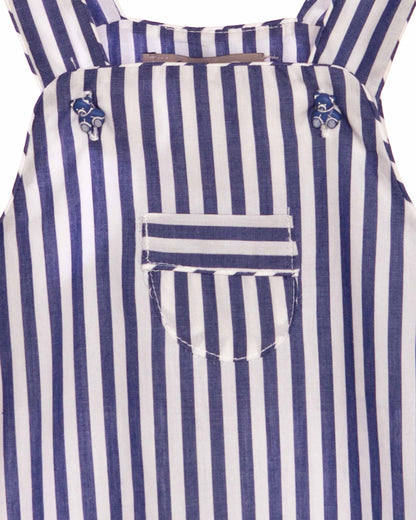 Close up of fabric of Blue and white striped shortall with a pocket on a white background