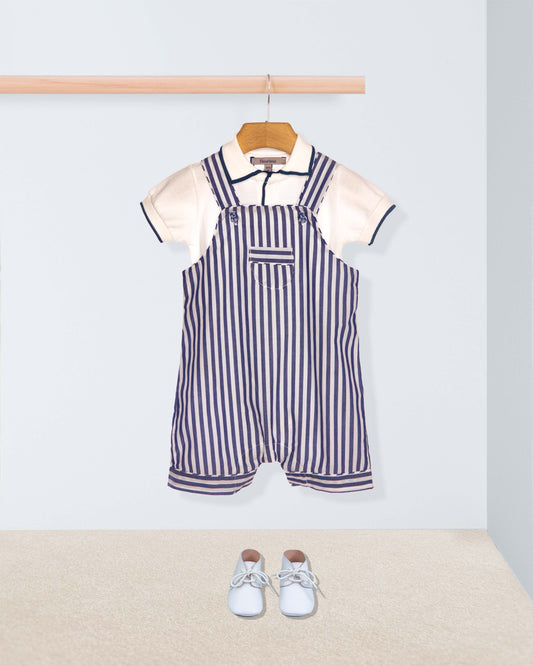 Striped overalls with a white shirt on a hanger against a light gray background.