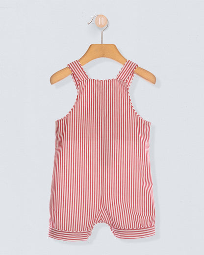 Back of red and white striped shortall on a wooden hanger against a light gray background