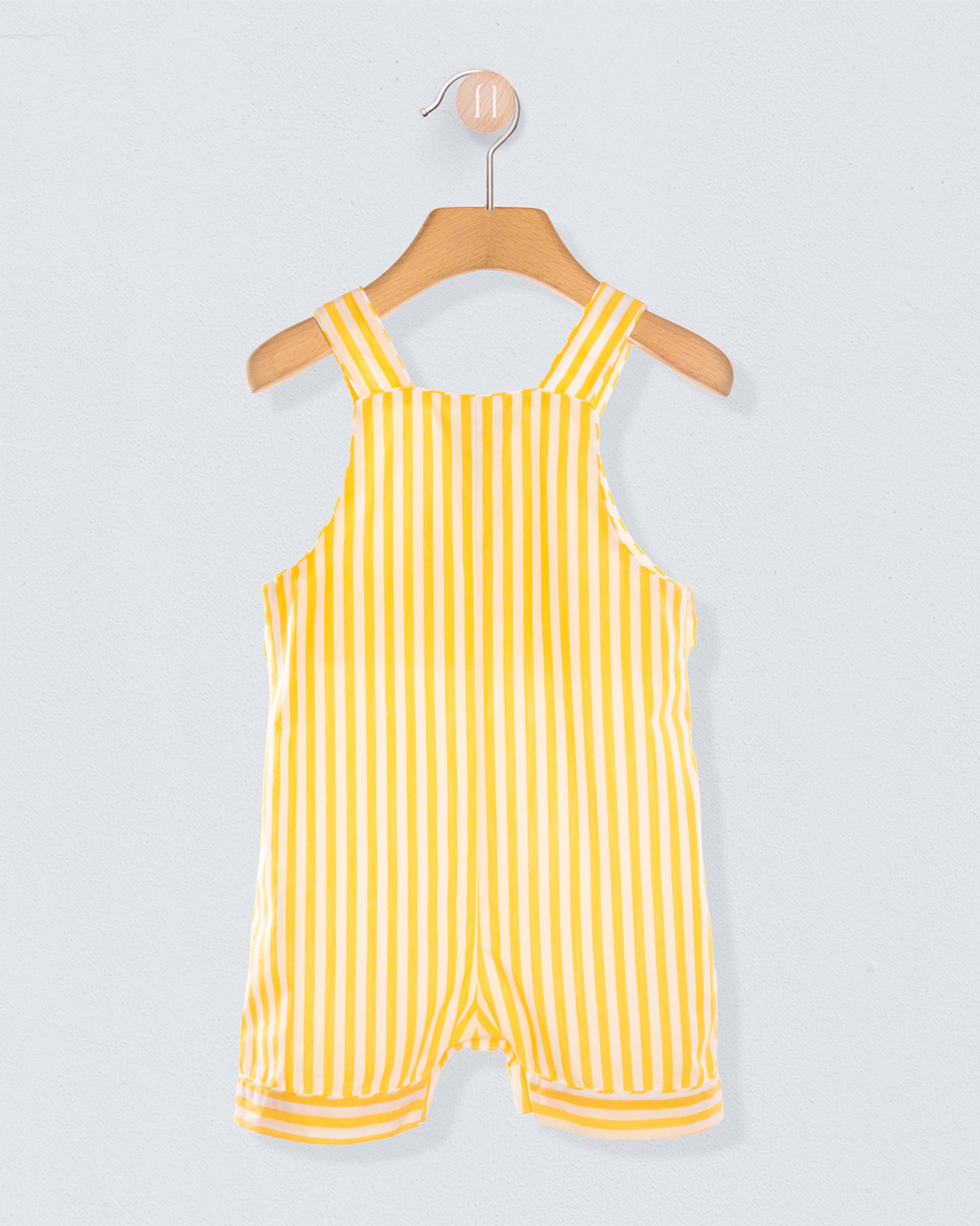 Back of Yellow striped shortall on a hanger against a light gray background