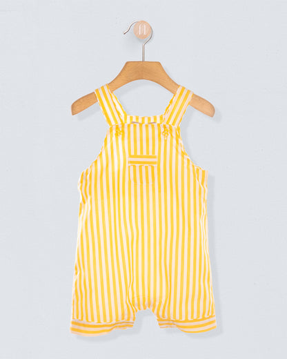 Yellow and white striped shortall on a hanger against a light gray background