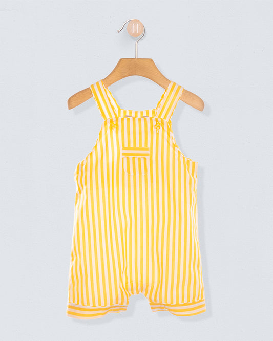 Yellow and white striped shortall on a hanger against a light gray background