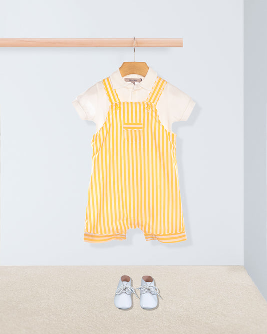 Yellow striped shortall with white shirt and white shoes on a light gray background