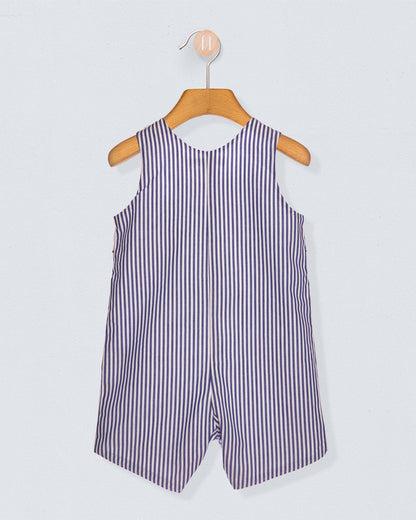Back of striped romper on a wooden hanger against a light gray background
