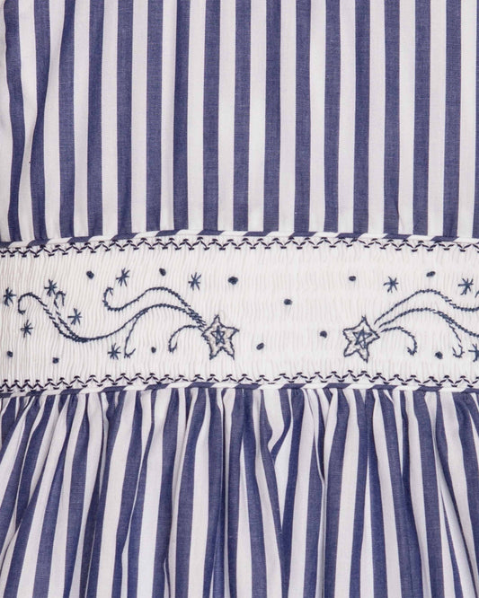 Close-up of blue and white striped fabric with embroidered patterns