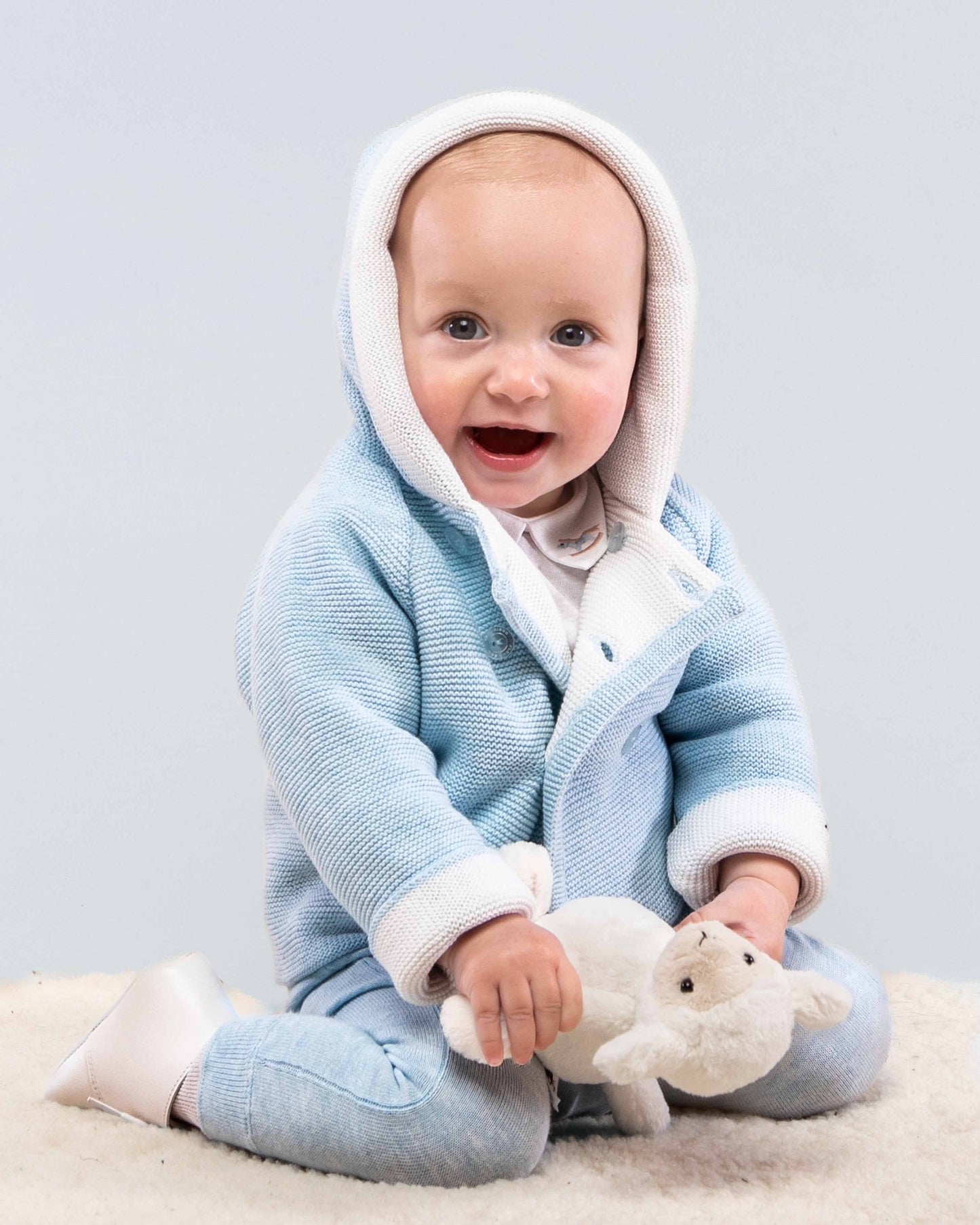 Jackpot Light Blue Hooded Sweater on baby sitting on floor holding sheep toy