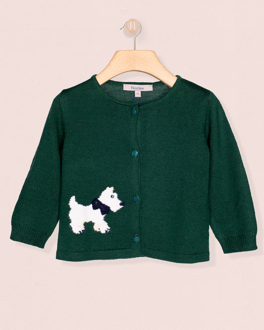 Green cardigan with a dog design on a hanger against a beige background