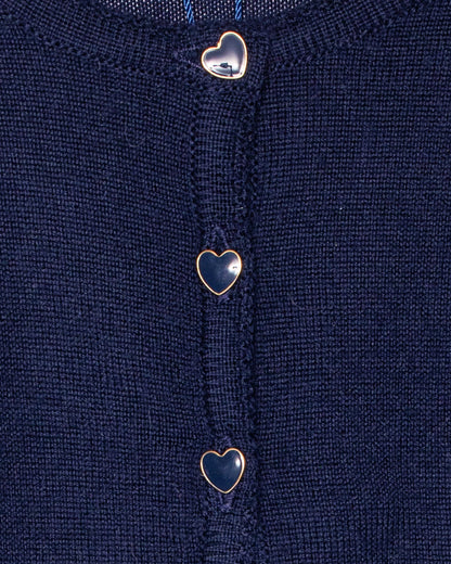 Close-up of a navy blue fabric with heart-shaped buttons.