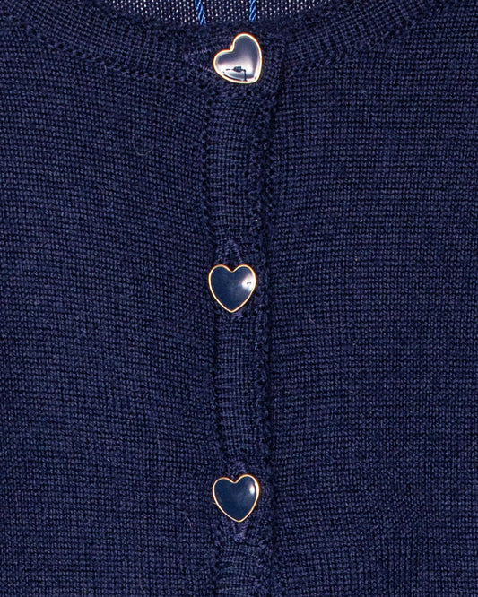 Close-up of a navy blue fabric with heart-shaped buttons.