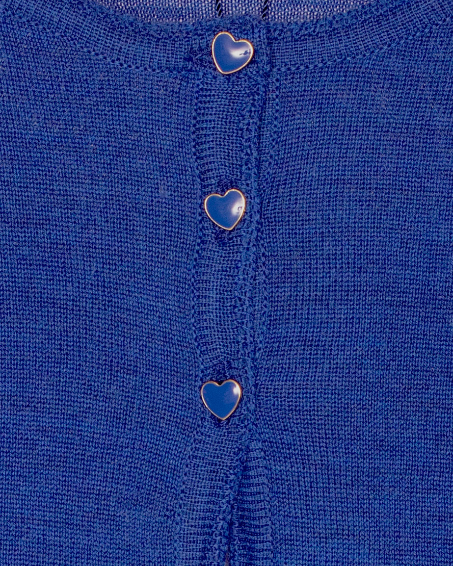 Close-up of a blue fabric with heart-shaped buttons