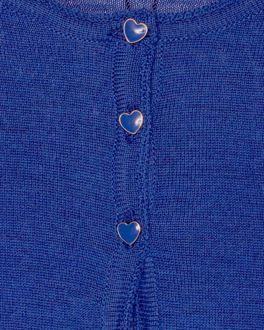 Close-up of a blue fabric with heart-shaped buttons