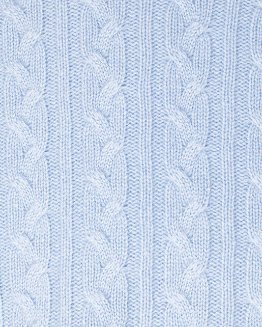 Close-up of a light blue knitted fabric with cable pattern