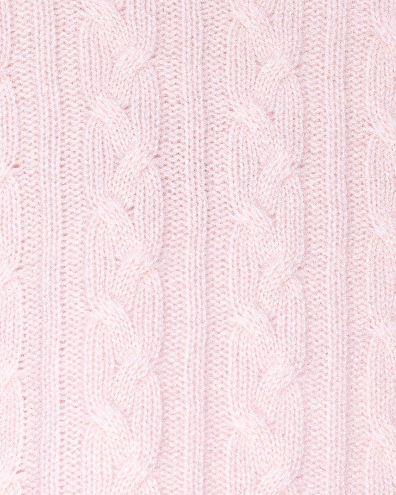 Close-up of pink knitted fabric with cable pattern