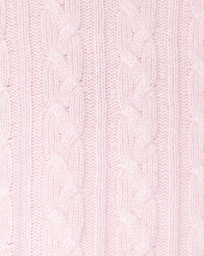 Close-up of pink knitted fabric with cable pattern