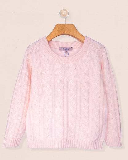 Pink sweater on a wooden hanger against a beige background