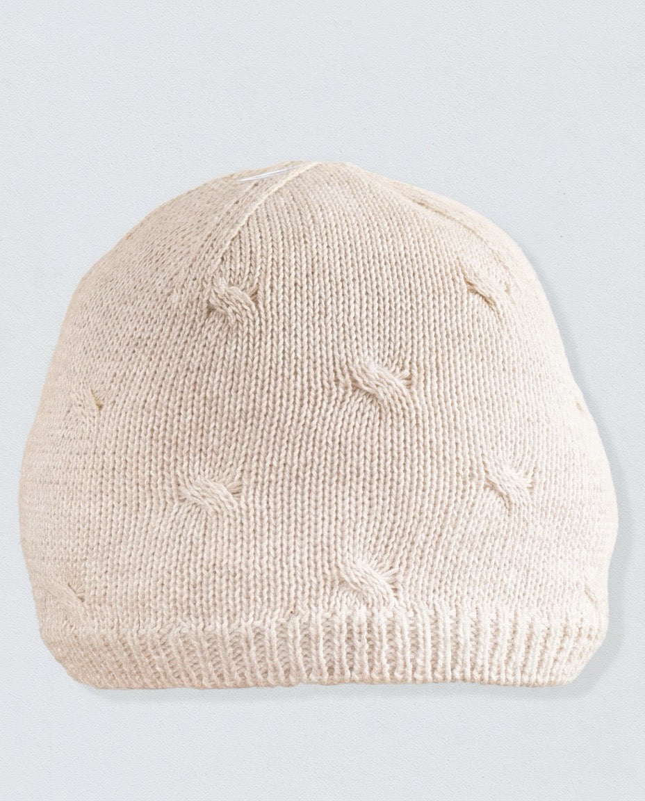Beige knit beanie on a light gray background